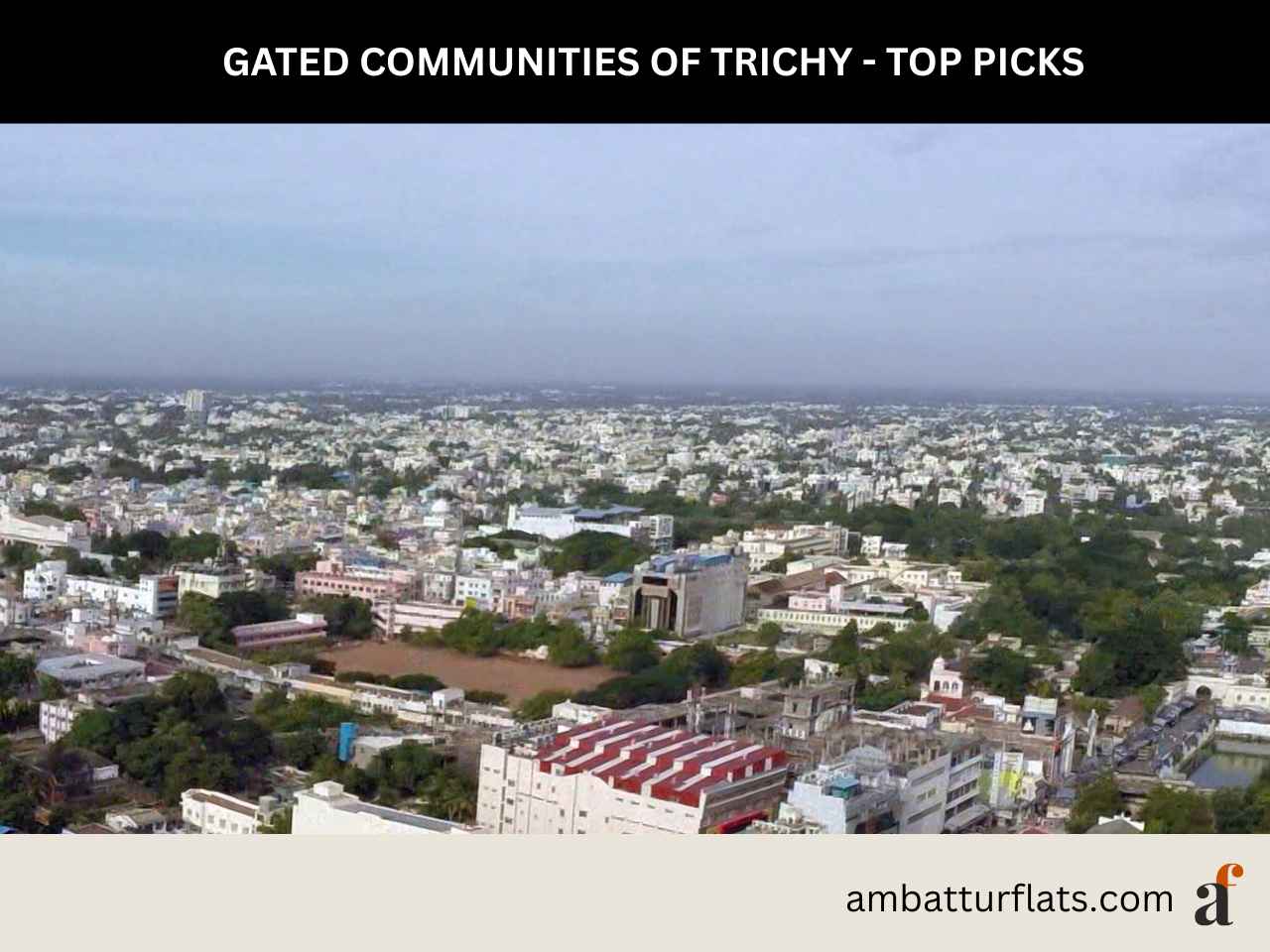 High-angle view of modern gated community apartment complexes in Trichy with landscaped amenities, with the ambatturflats.com logo.